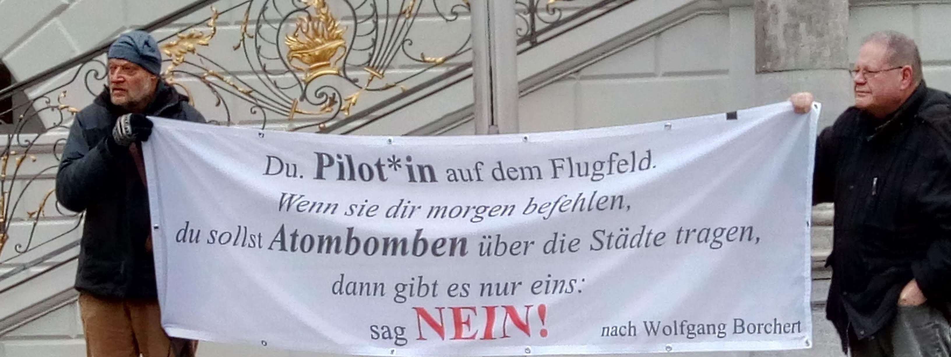 Zwei aktivisten halten eoin Banner mit einem Zitat von WQolfgang Borcherts